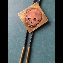 Load image into Gallery viewer, Memento Mori Skull Bolo Tie in Copper, Brass and Leather with Sterling Silver Teeth
